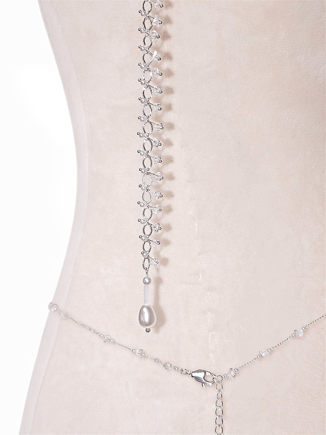 Pearl body chain at the waist