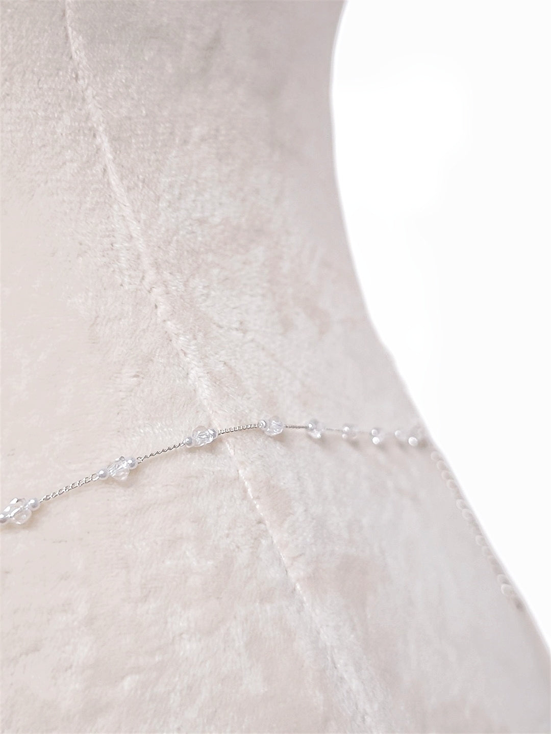 Pearl body chain at the waist, close